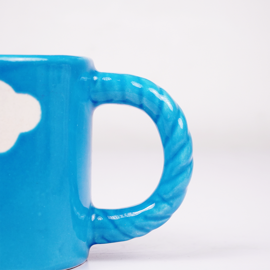 Blue Ceramic Coffee Mug with White Cloud Design & Textured Handle