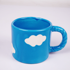Blue Ceramic Coffee Mug with White Cloud Design & Textured Handle