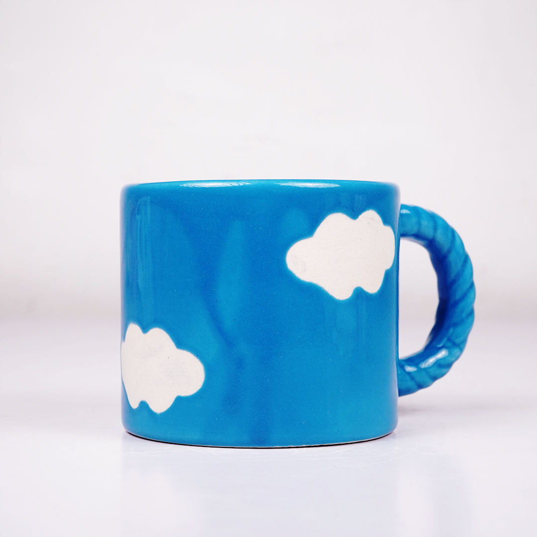 Blue Ceramic Coffee Mug with White Cloud Design & Textured Handle