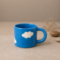 Blue Ceramic Coffee Mug with White Cloud Design & Textured Handle